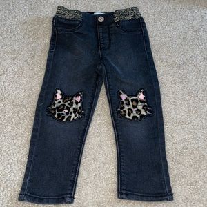 Black stretch skinny jeans with cat patch knees